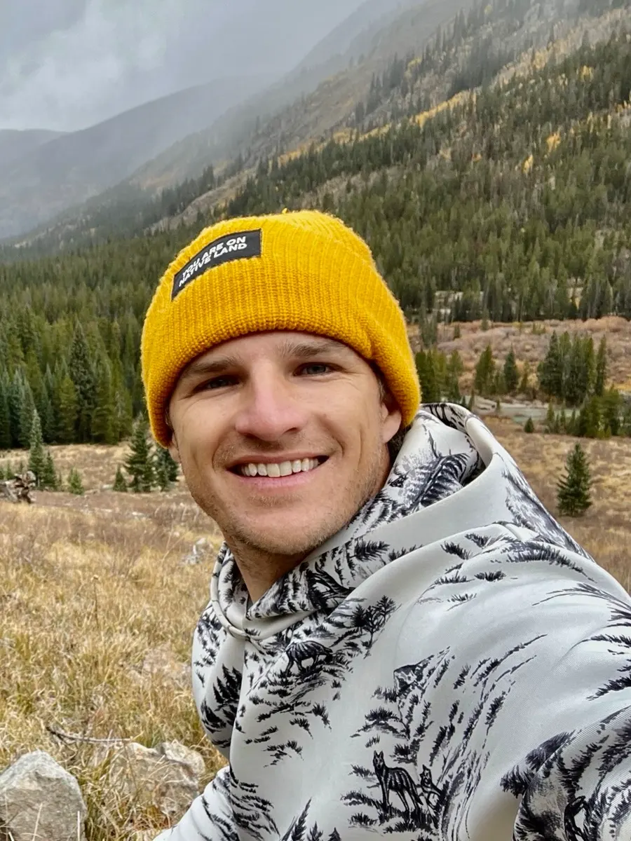 Portrait of Morgan Hoffmann at golden hour on a mountain ridge