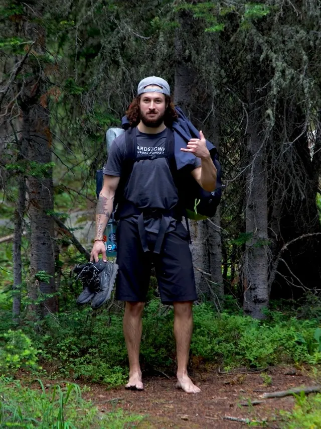 Portrait of Skye seated by a mountain stream